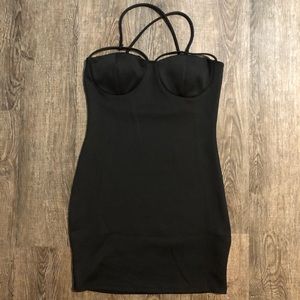 Simple black dress with cross strap details.